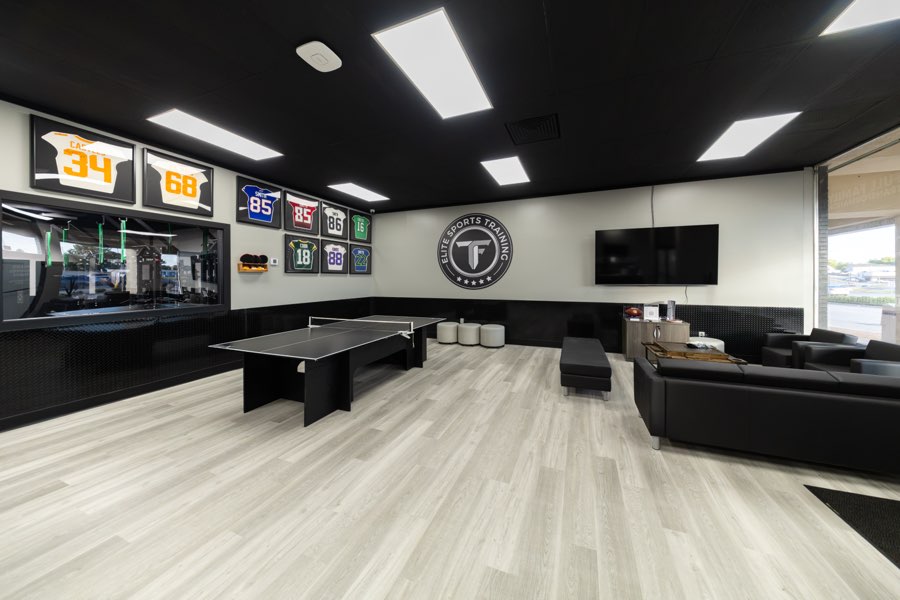 The member lounge with a table tennis table, seating and framed jerseys.