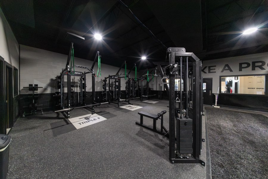 A row of Triple F power racks and a cable tower around the lifting platforms.